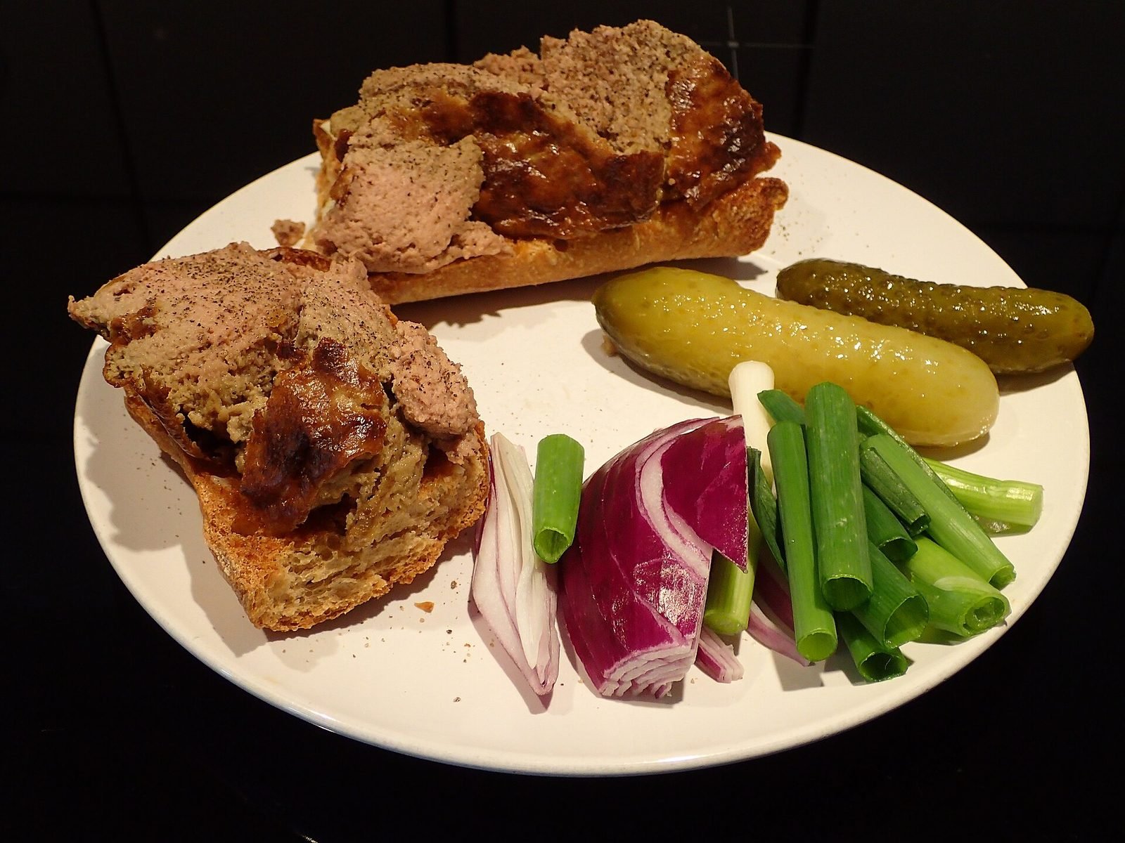 Danish liver p&acirc;t&eacute; on bread with pickled gherkins, red onion and spring onions