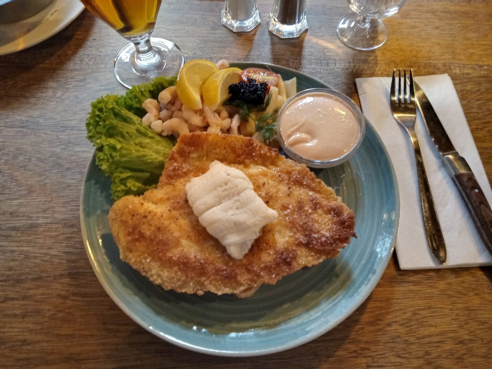 Stjerneskud on a plate: fried plaice fillet with prawns, lettuce, lemon and roe on toasted bread
